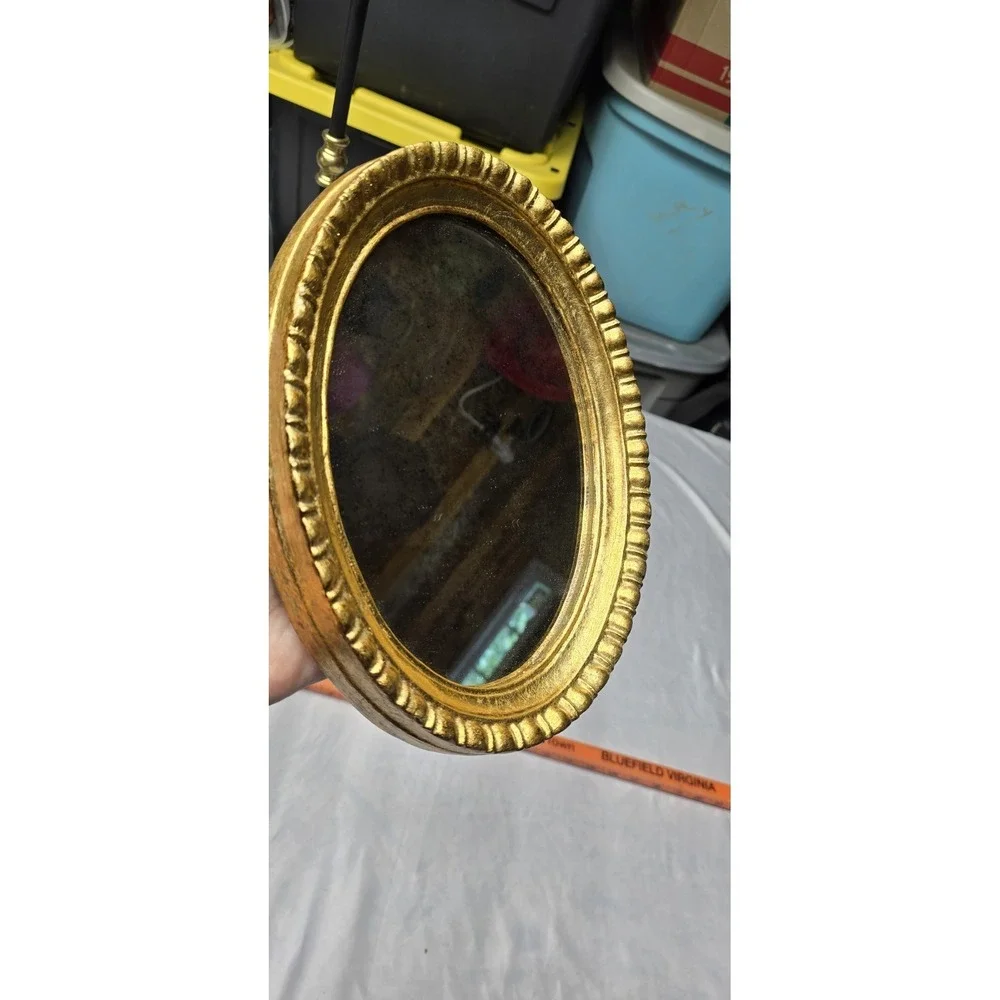 Vintage Or Antique Oval Wall Mirror with An Ornate Gold Gilt Frame